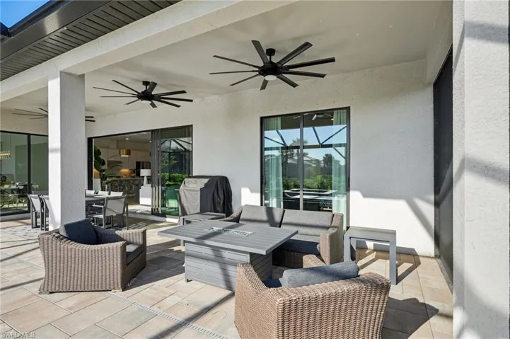 View of patio with ceiling fan and an outdoor living space