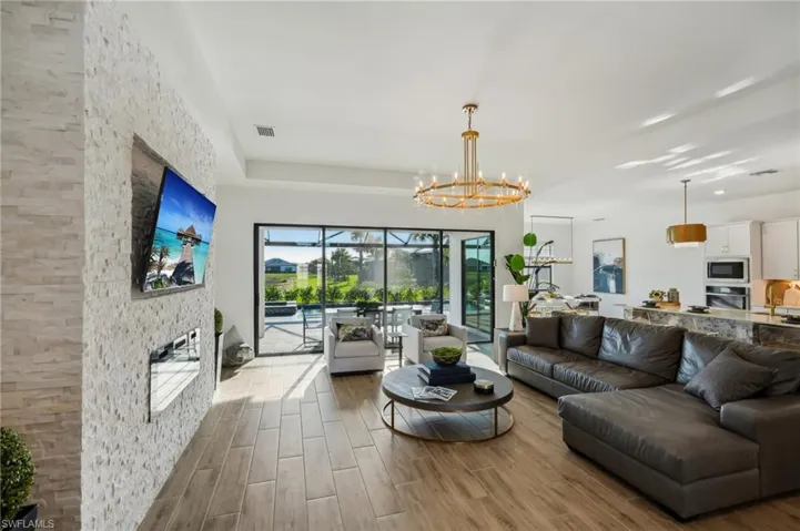 Living room featuring hardwood / wood-style floors and an inviting chandelier