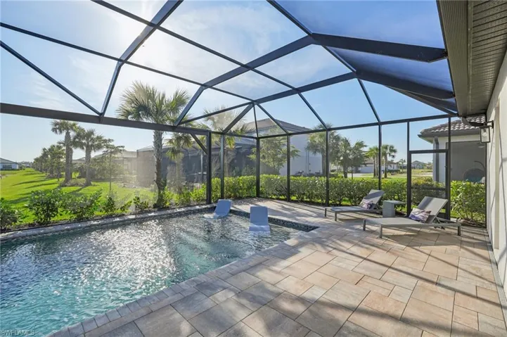 View of swimming pool featuring a lanai and a patio area