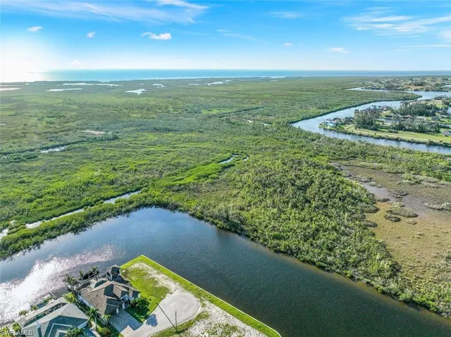 Birds eye view of property with a water view