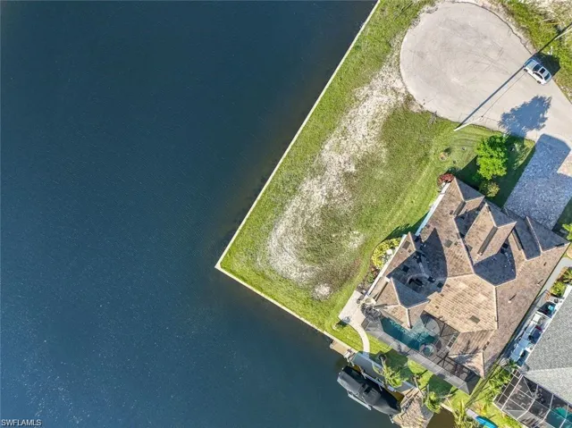 Birds eye view of property with a water view