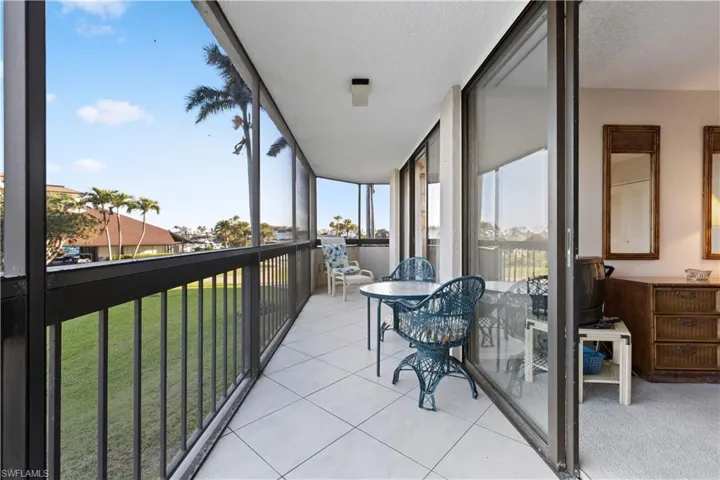 Balcony wraps around side which overlooks bay