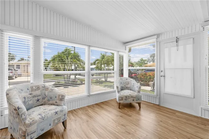 Sunroom featuring a wealth of natural light and lofted ceiling