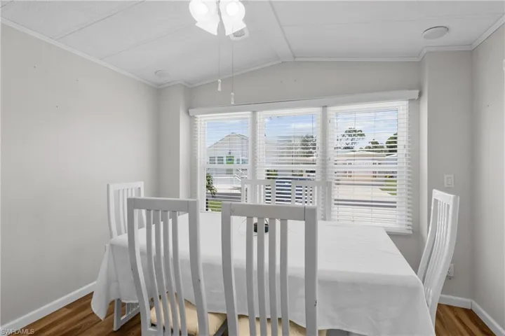 Dining area featuring lofted ceiling, plenty of natural light, and hardwood / wood-style floors