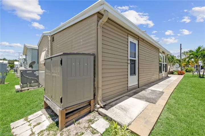 View of outdoor structure with a yard