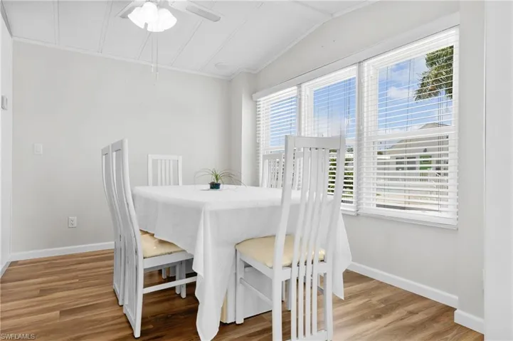 Dining space with ceiling fan, plenty of natural light, light hardwood / wood-style flooring, and lofted ceiling