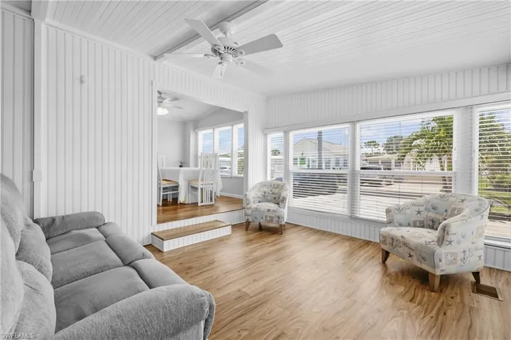 Sunroom featuring a wealth of natural light and ceiling fan
