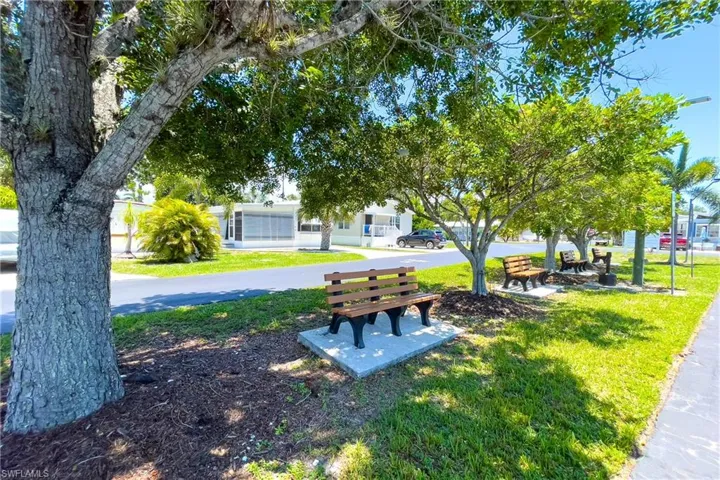 View of property's community with a lawn