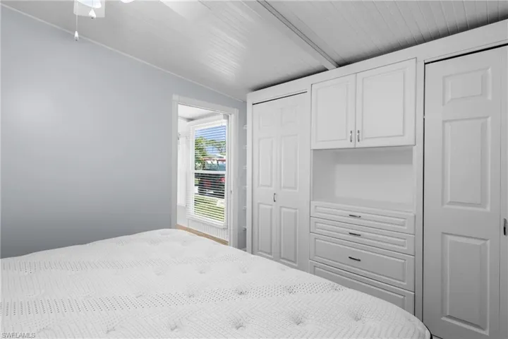 Bedroom with ceiling fan and lofted ceiling