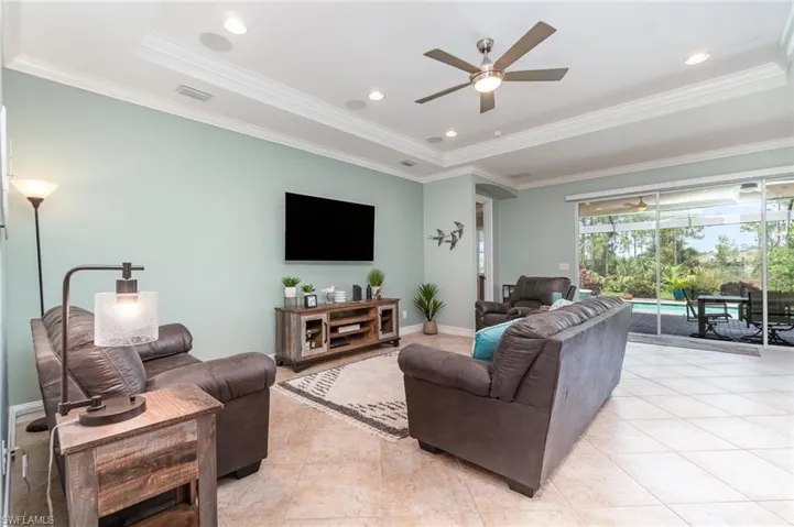 Picturesque views of the pool/spa & lanai from the triple sliders.
