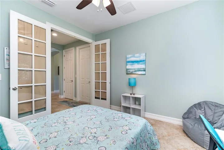 Den includes french doors with curtains for privacy.