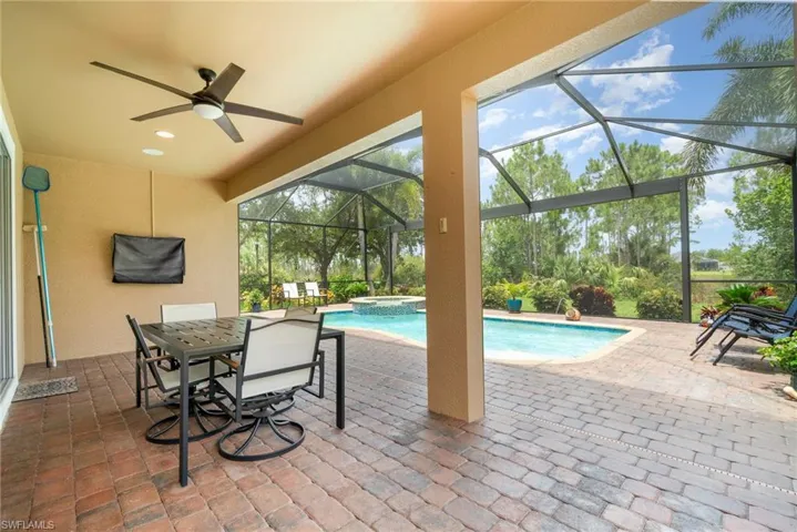 View of large screened in lanai with a pool and spa.