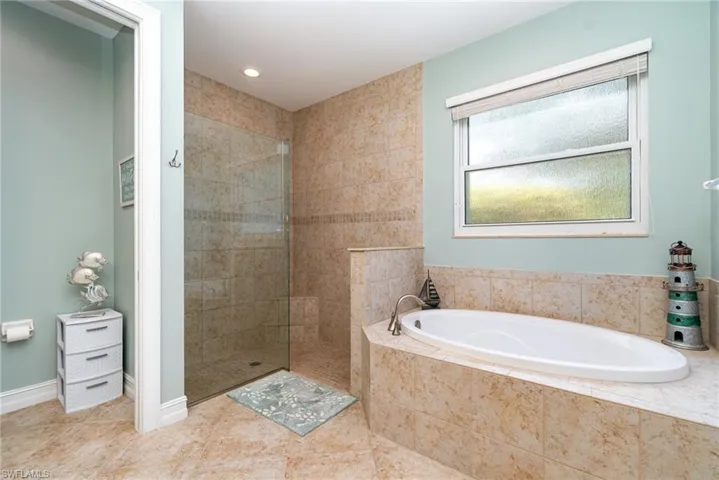 The primary ensuite also includes a garden tub with a window above offering an abundance of natural light.