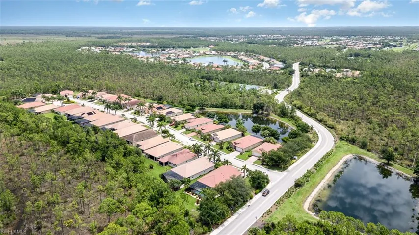 Aerial overview of property's location with a large body of water and nearby suburban area