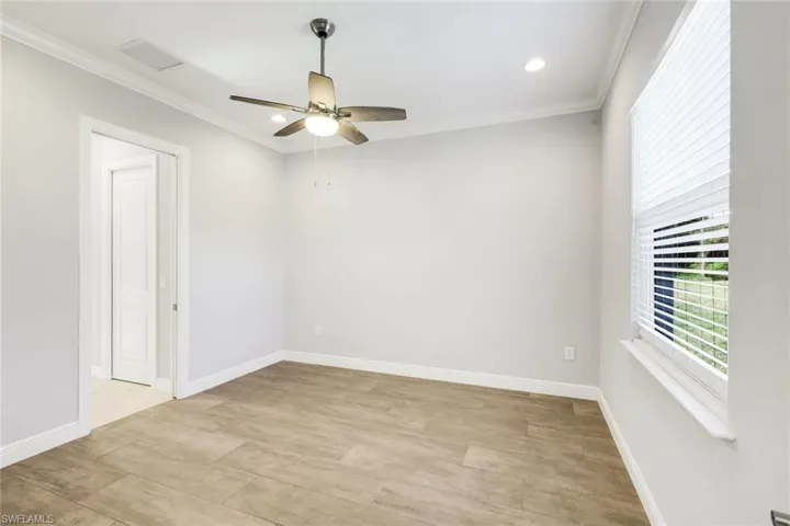 Empty room with recessed lighting, crown molding, light wood-style flooring, and ceiling fan