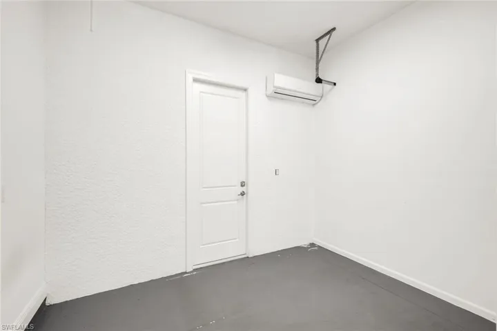 Garage featuring an AC wall unit