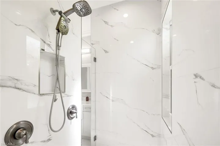 Bathroom with a marble finish shower