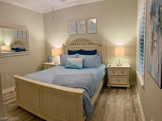 Bedroom with ornamental molding and light wood-style floors
