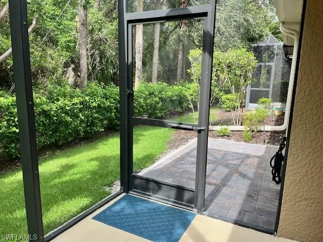 Doorway to outside featuring a textured wall