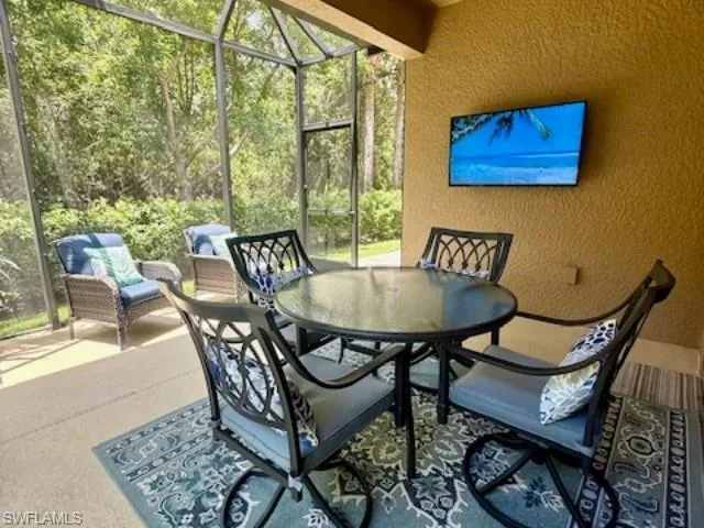 Sunroom / solarium featuring outdoor dining area