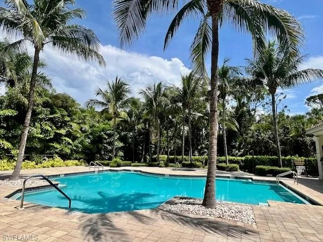 Community pool with a patio