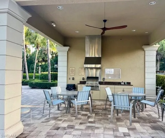 View of patio / terrace featuring outdoor dining space, exterior kitchen, and ceiling fan