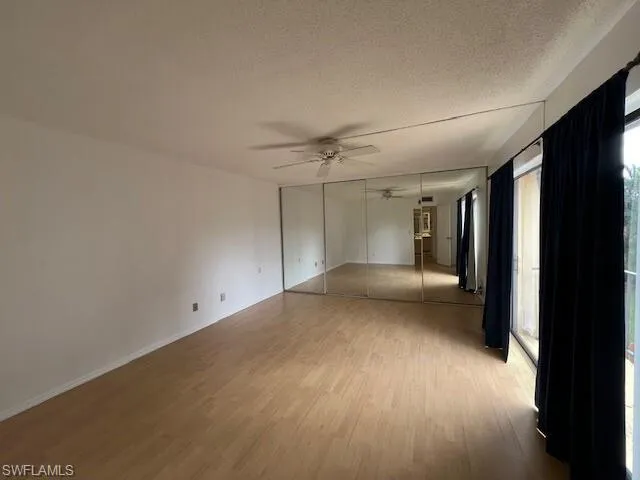 Spacious primary bedroom with a large closet and private balcony.