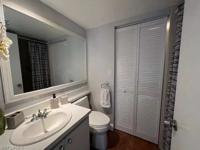 Downstairs bathroom with walk in shower and attached laundry room.