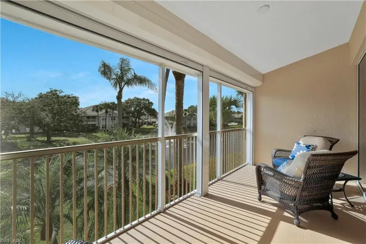 Sunny lanai with view of lake and fountain