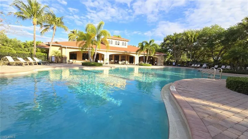 Community pool with fence and a patio area