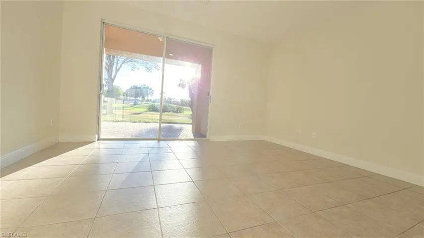 Spare room featuring baseboards and light tile patterned floors
