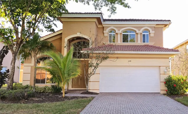 Mediterranean / spanish-style house featuring a tile roof, decorative driveway, and stucco siding