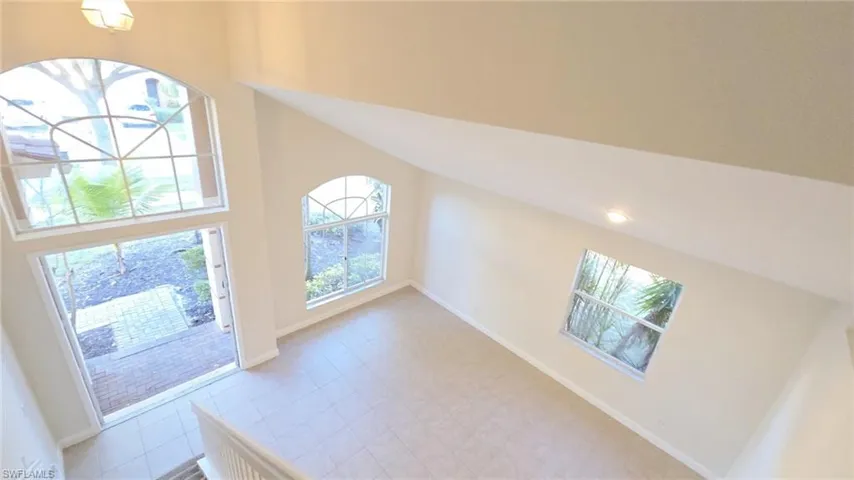 Foyer with a towering ceiling and baseboards