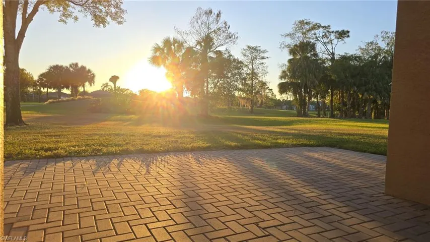 View of property's community featuring a yard and a patio area
