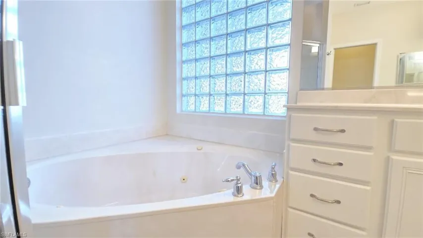 Bathroom with a jetted tub and vanity