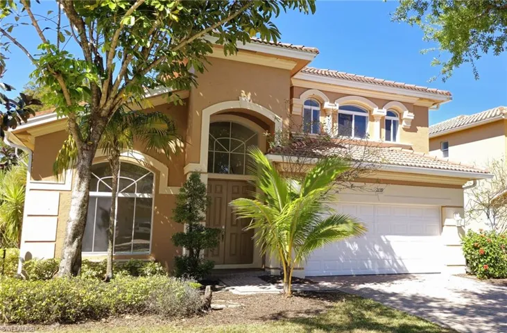 Mediterranean / spanish-style home featuring driveway, stucco siding, a tile roof, and a garage