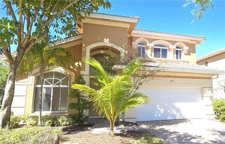 Mediterranean / spanish home featuring driveway, stucco siding, a tile roof, and a garage