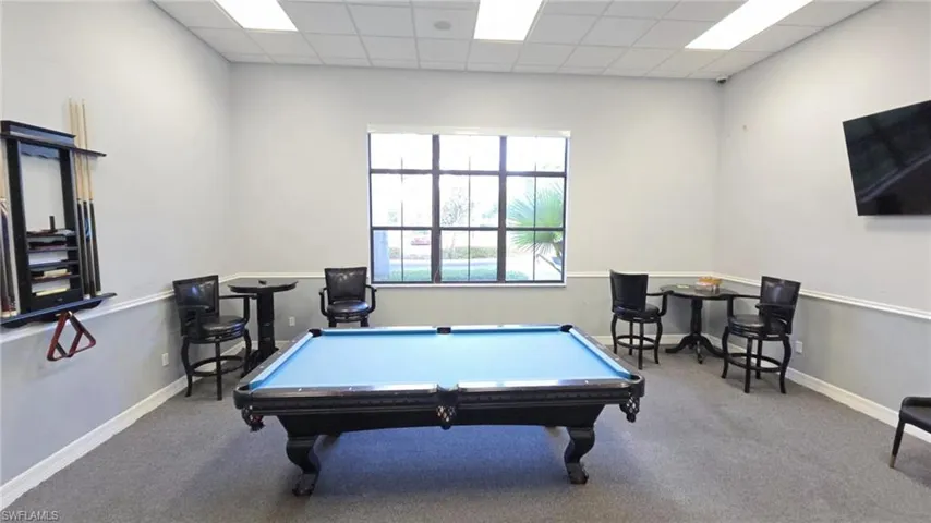 Recreation room with carpet flooring, billiards, and baseboards