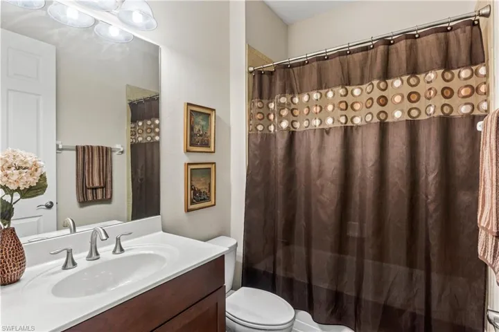 Designed with comfort and style, featuring a tub/shower combo and bright lighting.
