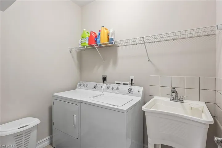 Spacious laundry room with a laundry tub and practical layout for everyday convenience.