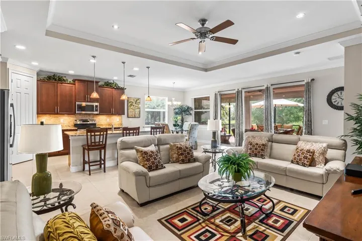 Natural light pours in through triple sliders, creating a seamless indoor-outdoor feel.