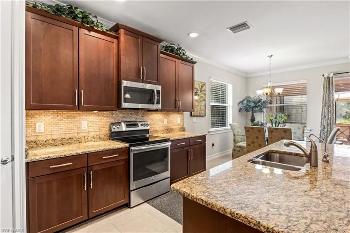 Granite countertops, stainless steel appliances, large pantry, and plenty of prep space.