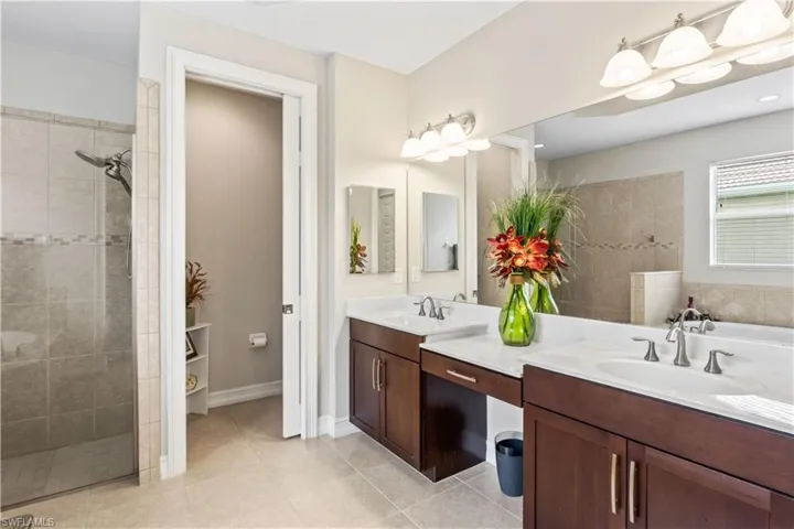 Dual vanities, deep soaking tub, and large walk-in shower offer everyday luxury.