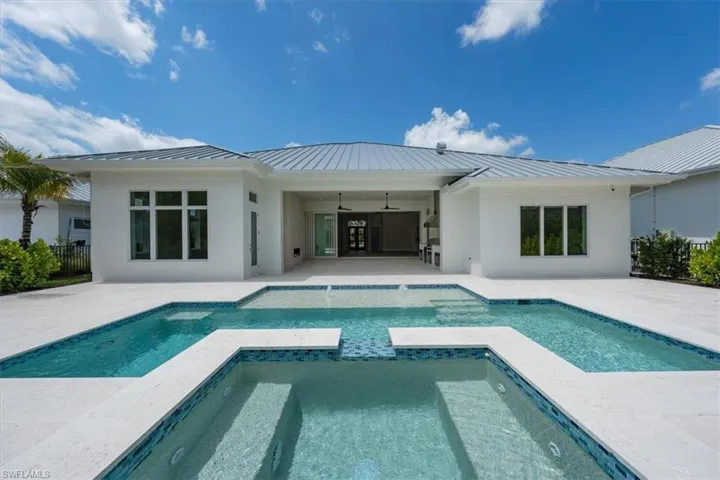 The heated salt swimming pool with raised in-ground spa and sun shelf set the stage for fun in the sun!
