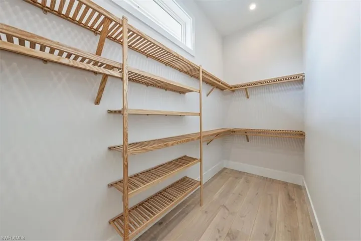 One of two primary bedroom closets. All closets are complete with natural grain Copewood closet systems.