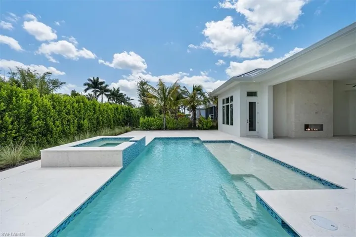 The heated salt swimming pool with raised in-ground spa and sun shelf set the stage for fun in the sun!