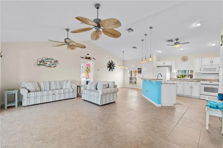 Bright and airy living room area and kitchen -Virtually enhanced