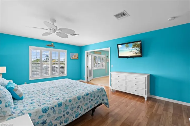 Coastal style primary bedroom -Virtually enhanced