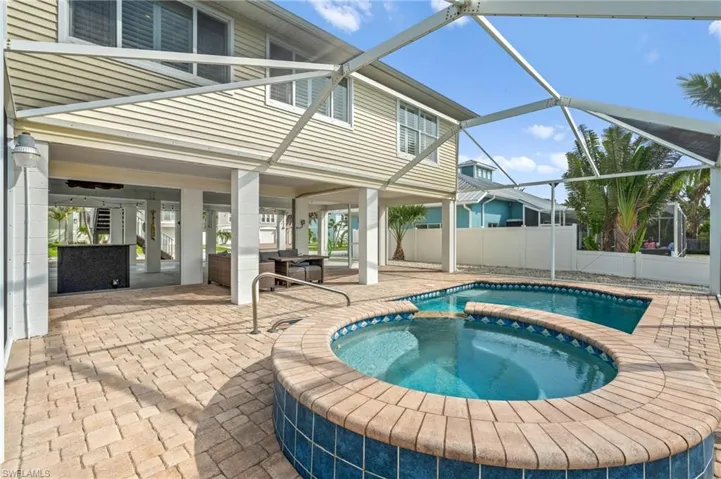 Pool & hot tub with covered area underneath house for relaxing & entertaining -Virtually enhanced