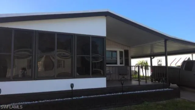 Rear view of property featuring a sunroom